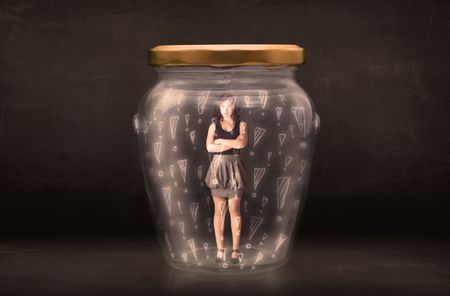 Business woman trapped in jar with exclamation marks concept on bakcground