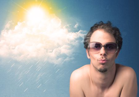 Young person looking with sunglasses at clouds and sun concept on blue background