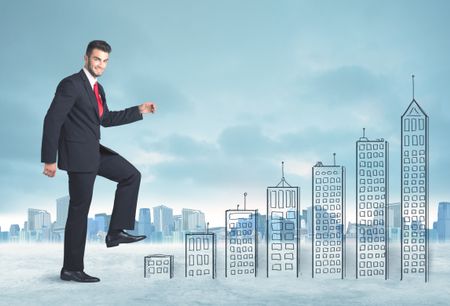 Business man climbing up on hand drawn buildings in city concept