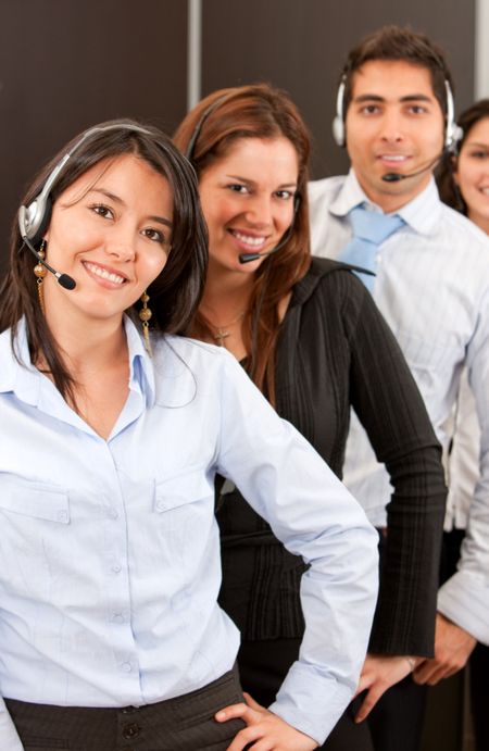 business customer support team in an office with headsets