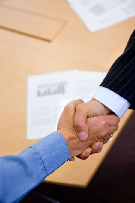 Close up of two business men shaking hands - business concepts