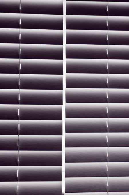 Two sets of venetian blinds side by side