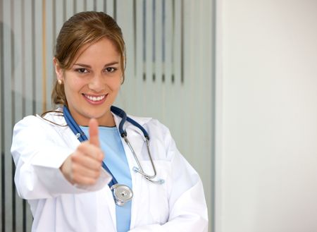 female doctor in a hospital with thumb up