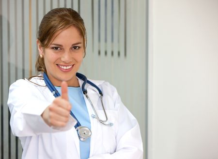 female-doctor-hospital-thumb-23907676 female doctor in a hospital with thumb up