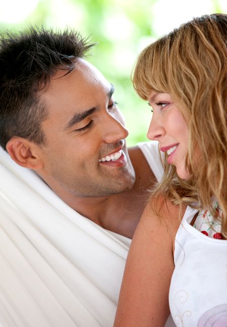Beautiful couple in love - smiling at each other outdoors