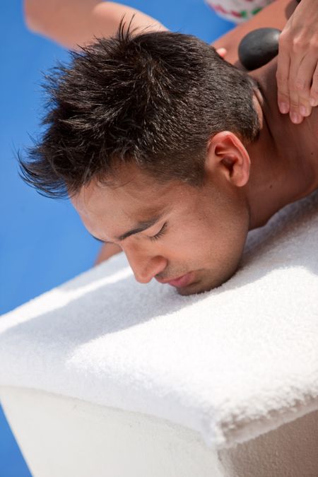 Beauty and Spa - Girl with zen stones on her back