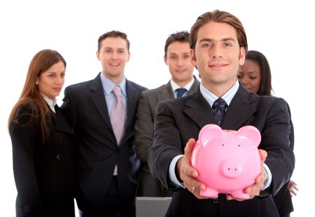 Business man showing his savings in a piggy bank with his team behind him
