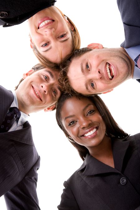 Business team with their heads together over a white background