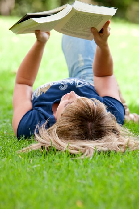 girl-reading-book-floor-outdoors-24045046 girl reading a book on the floor - outdoors