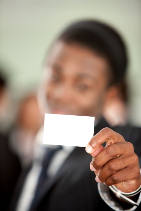 Businessman showing a business card in an office
