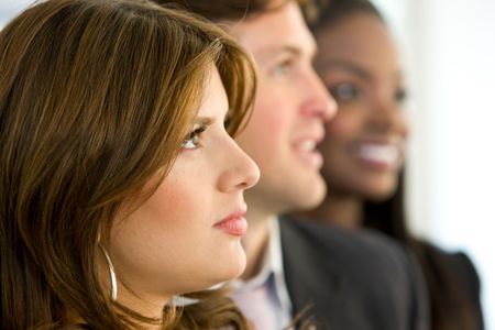 group of business people in a row looking up in an office