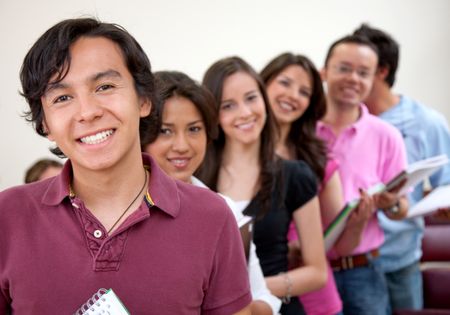 Group of students standing in a row at a classroom