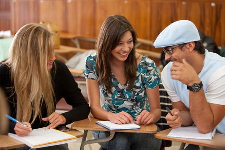 small group of students sitting in a classroom smiling