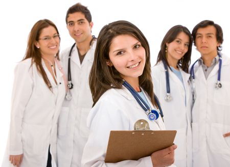 female doctor holding a stethoscope with her team behind her - isolated