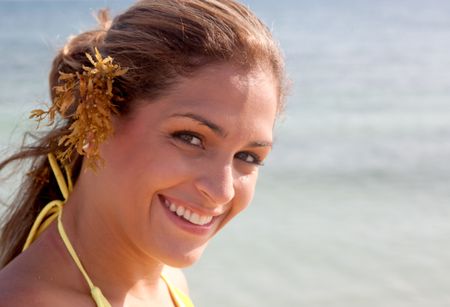 beautiful bikini woman smiling at the beach while on vacation
