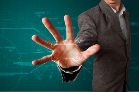 Young businessman pressing high tech type of modern buttons