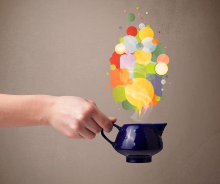 Coffee pot with colorful speech bubbles, close up