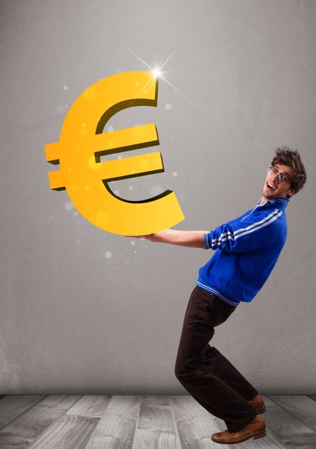 Good-looking young boy holding a big 3d gold euro sign