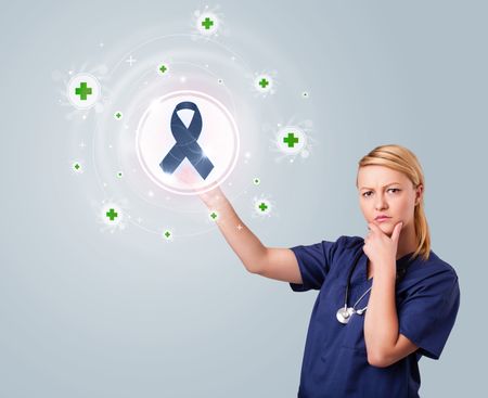 Young nurse standing and pressing modern medical type of buttons