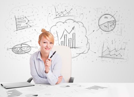 Business woman sitting at white table with hand drawn graph charts