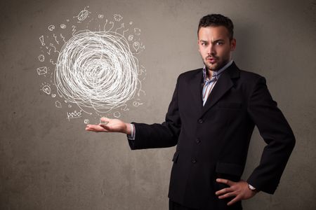 Young businessman holding chaos concept in his hand