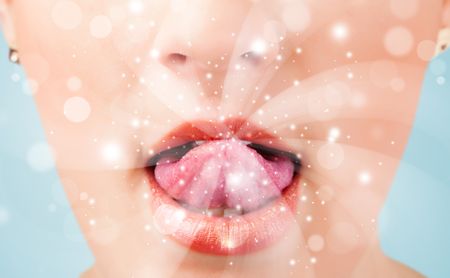 Pretty woman lips blowing abstract white lights - close up
