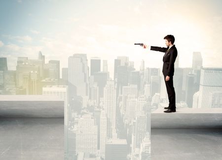Businessman standing on the edge of rooftop with city background