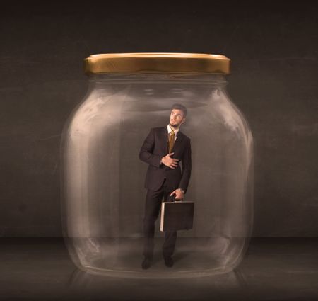 Businessman shut into a glass jar concept on background