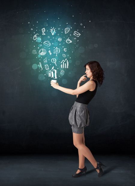 Businesswoman standing and holding a white cup with business icons coming out of the cup