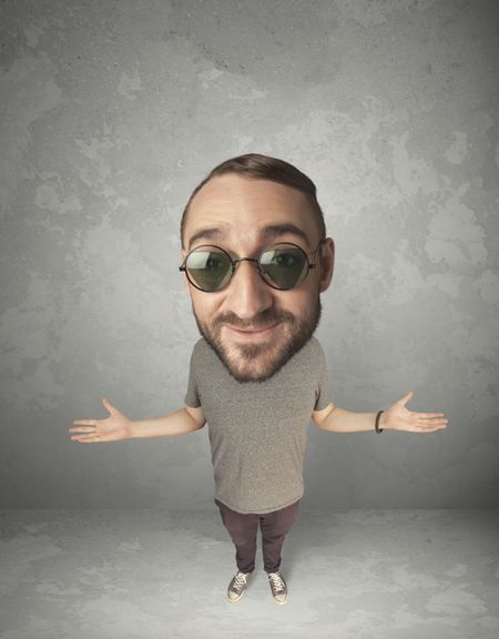 Funny person with big head on gray background