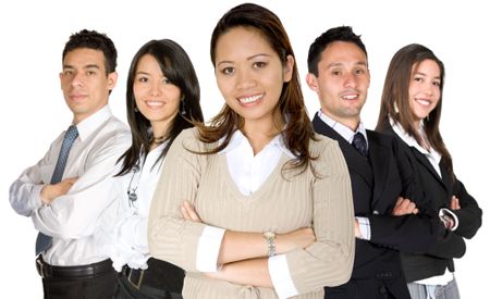 business woman facing the camera in a brown blouse with her team behind over white