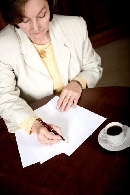 Business woman doing paperwork in her office
