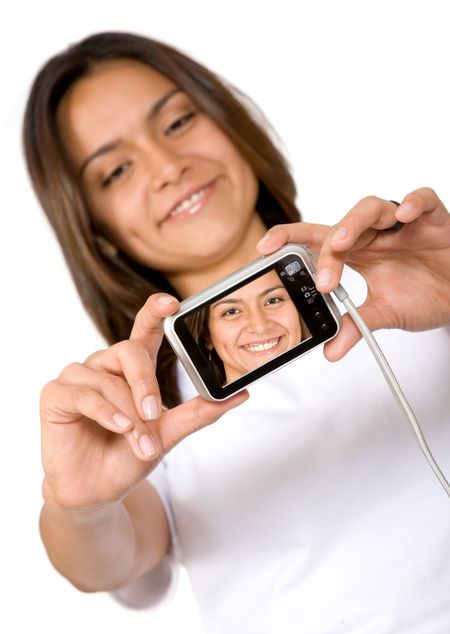 beautiful girl with a camera taking a photo of herself - focus is on camera