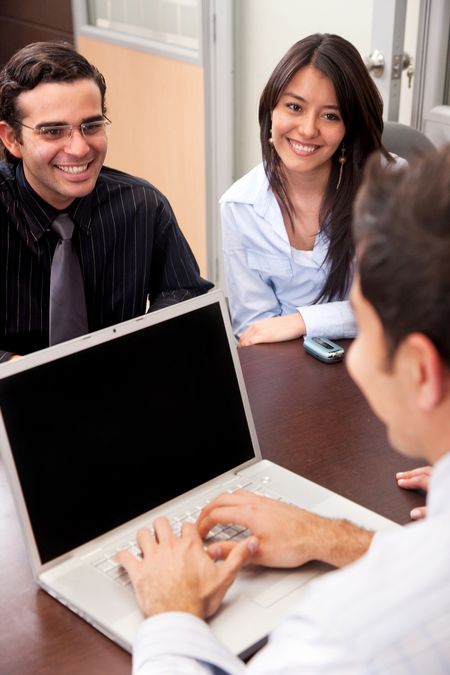 Partners having a business meeting with a manager in an office