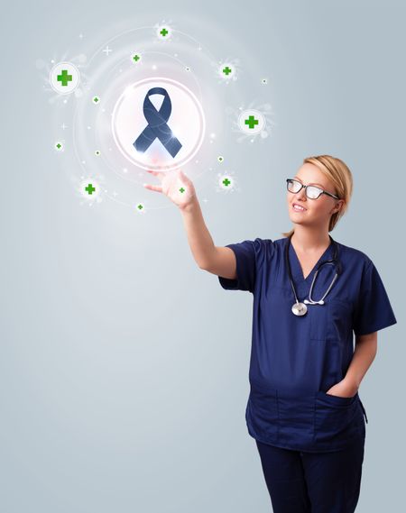 Young nurse standing and pressing modern medical type of buttons