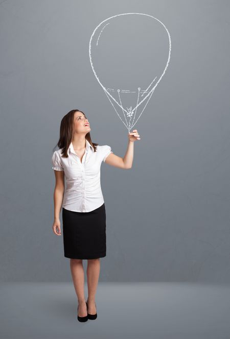 Beautiful young woman holding balloon drawing