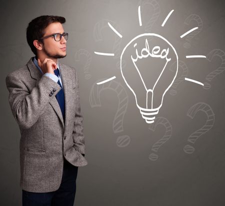 Attractive young boy comming up with a light bulb idea sign