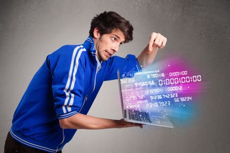 Casual young man holding laptop with exploding data and numbers