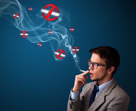 Attractive young man smoking dangerous cigarette with no smoking signs