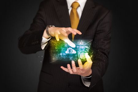 Businessman holding a shining data cloud in front of his body 