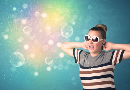 Young woman with sunglasses and bokeh colourful lights concept