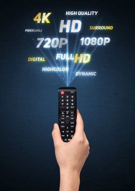 Hand holding a remote control, multimedia properties coming out of it 