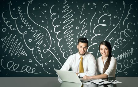 Business couple sitting at table with drawn curly lines and arrows on the background 