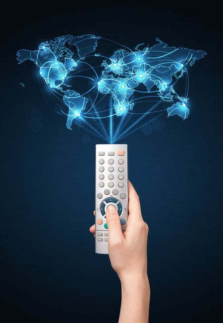 Glowing social network  world map coming out of a remote control 