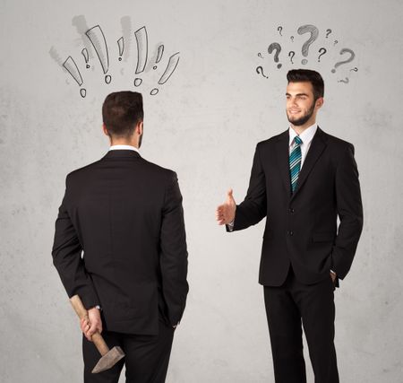 Ruthless businessman handshake with drawn exclamation and question marks around them head
