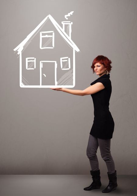 Beautiful young lady holding a huge drawn house