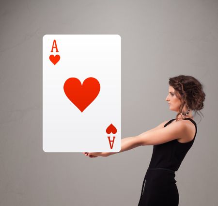 Beautifu young woman holding a red heart ace