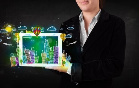 Young person showing tablet with hand drawn colorful cityscape