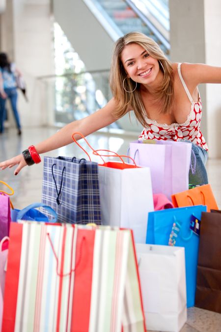 Happy woman with shopping bags in a mall