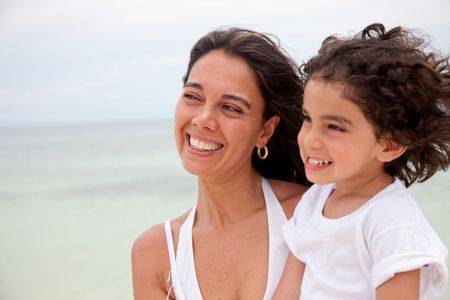 Beautiful portrait of a mother with her son at the beach
